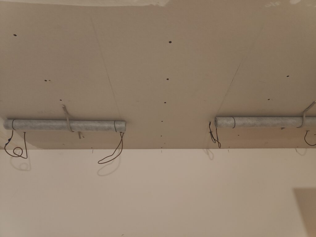 Cabling in place and the heat mats are ready to be plastered in. They are attached to the ceiling with some temporary cabling for now